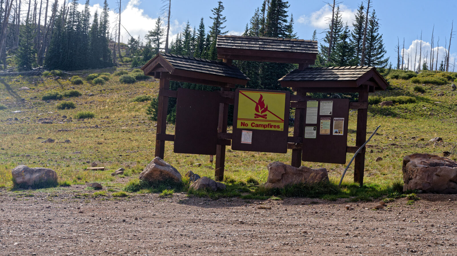 Display board with area information and a single-stall pit toilet. There is also a camp spot in the trees with some shade and privacy, room for about three rigs including trailers.