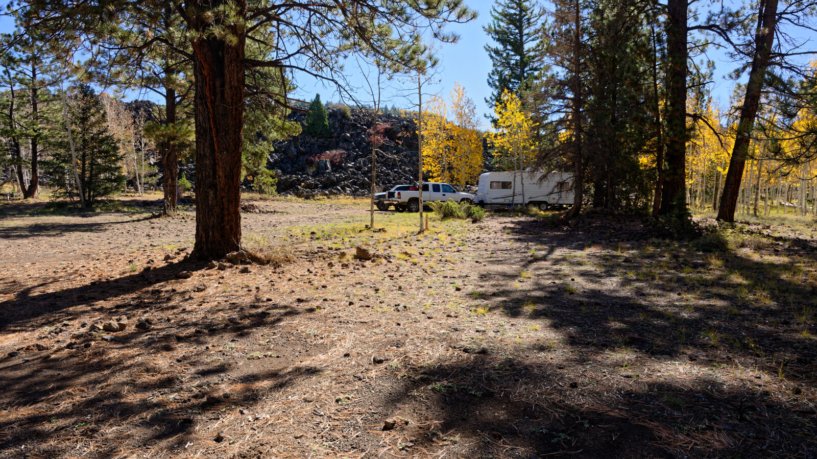 Shady camp spot in the trees, not private. Room for at least three rigs.