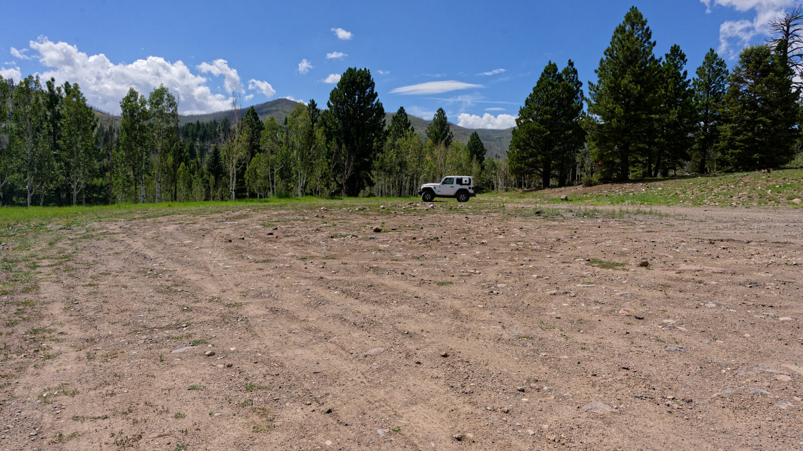 Open camping area, not private and not shady. Room for four or five rigs, trailers included.