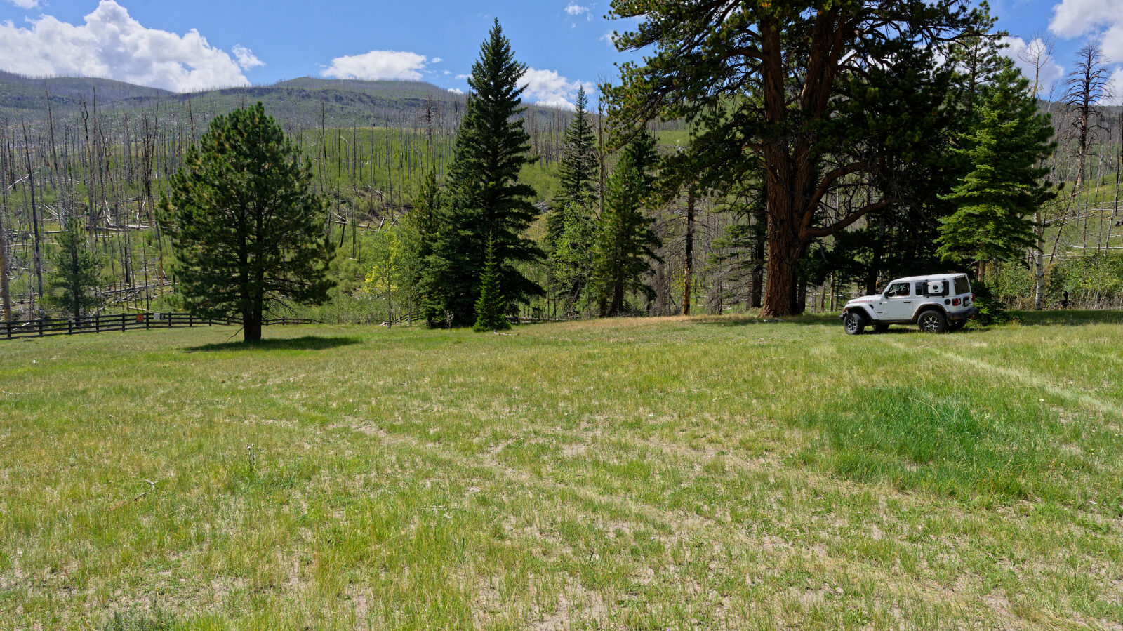 Camping spot for two or three rigs. It is shaded and not private, and near private property but not on it.