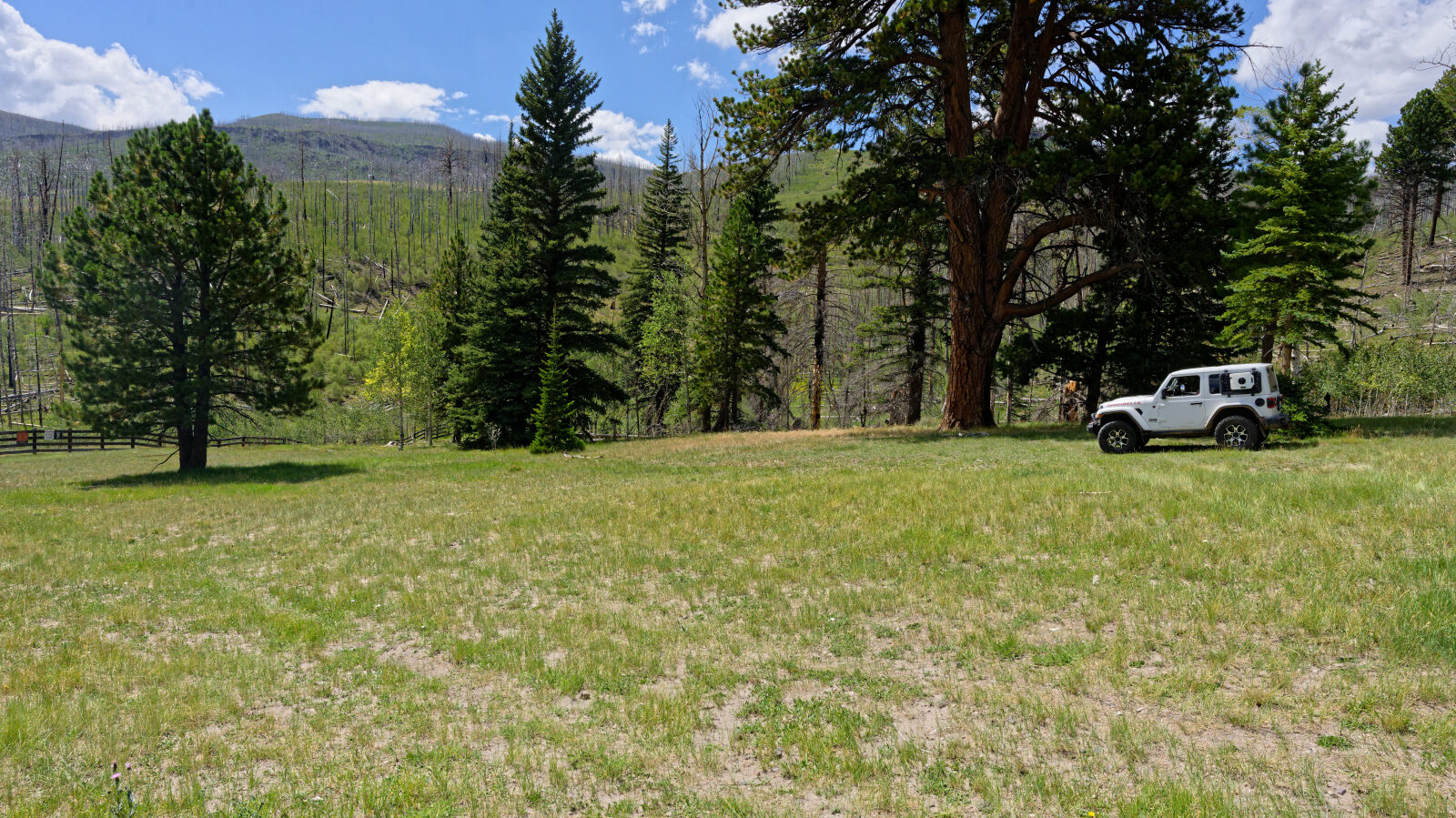 Camping spot for two or three rigs. It is shaded and not private, and near private property but not on it.