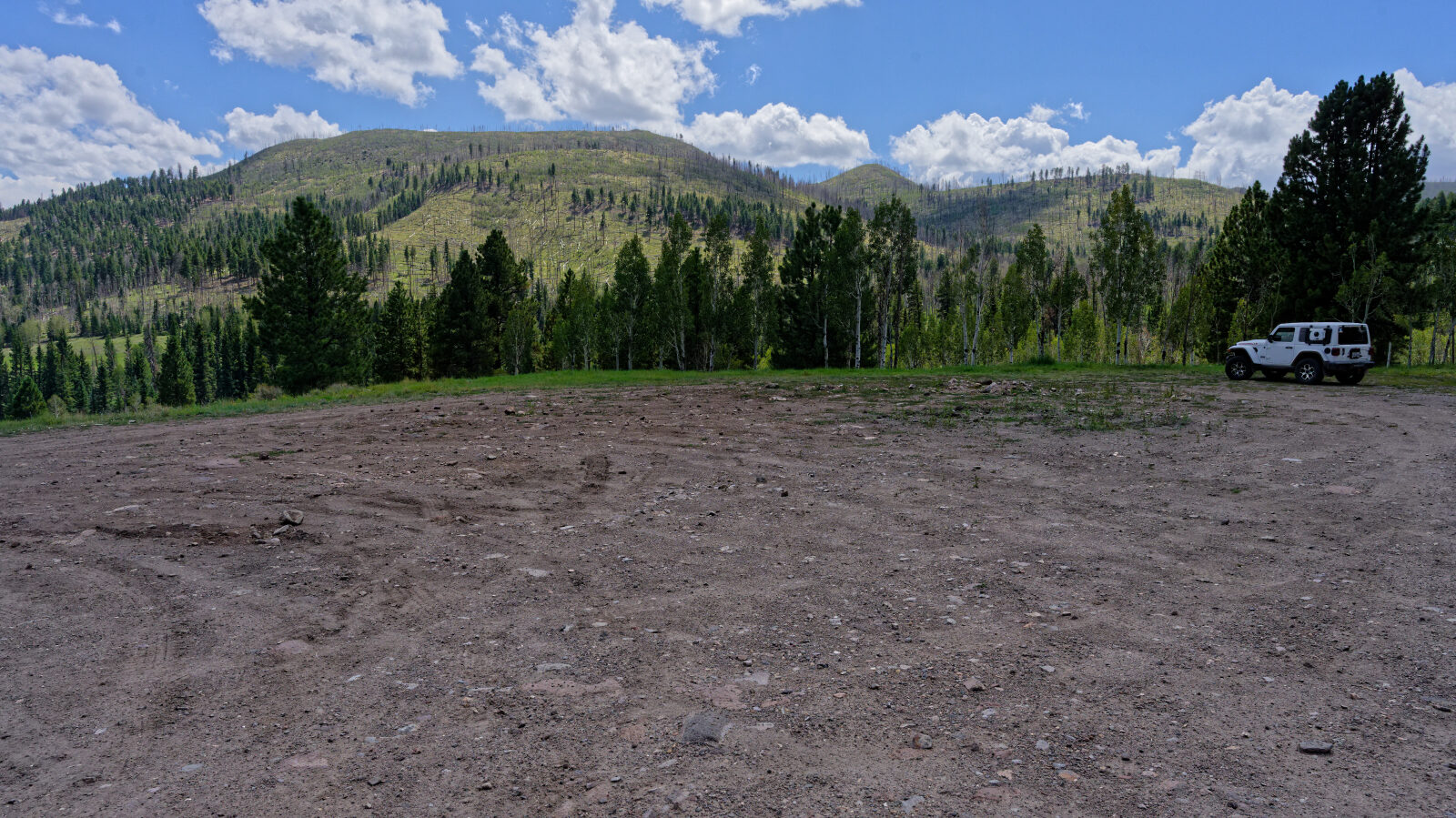 Open camping area, not private and not shady. Room for four or five rigs, trailers included.